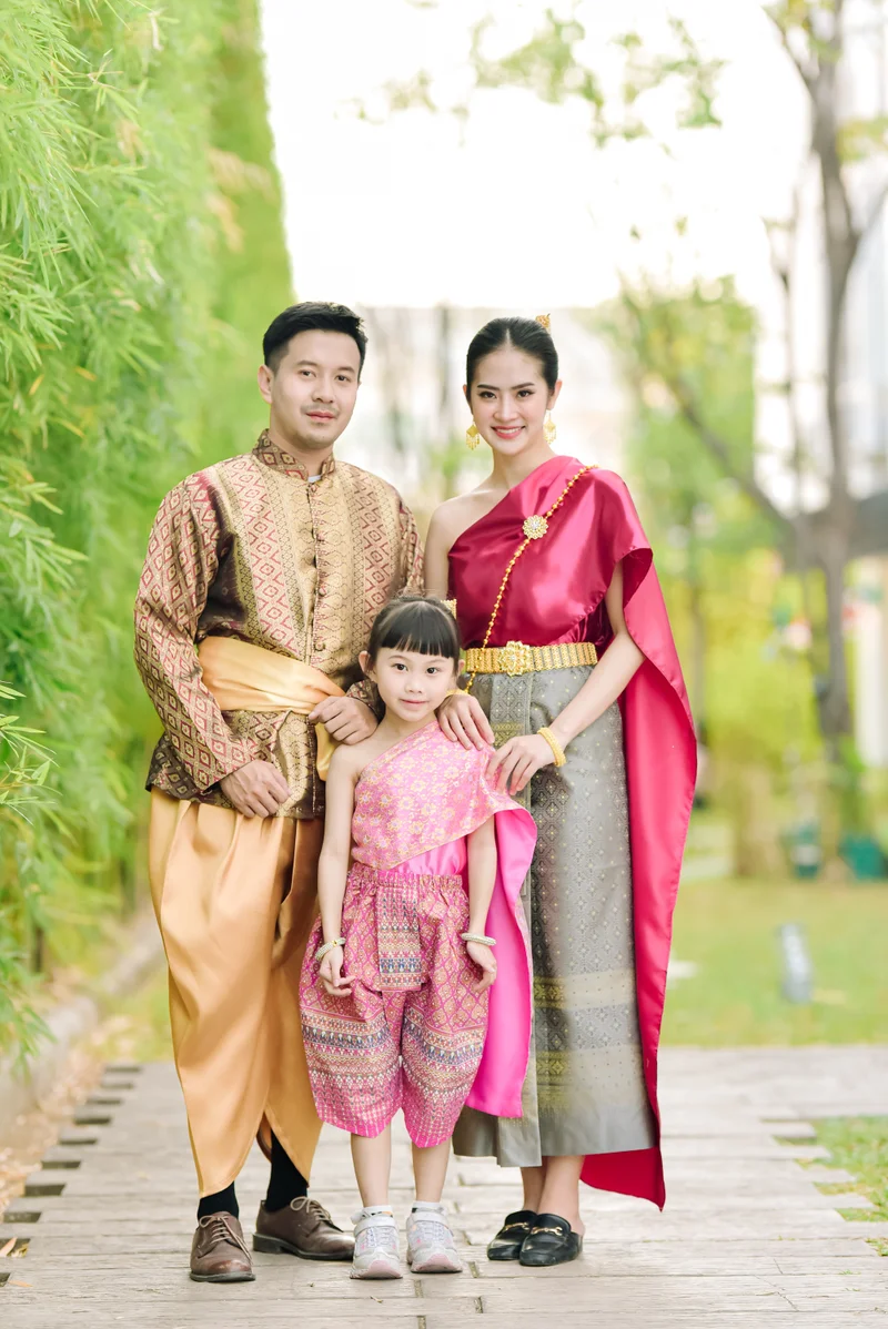 Child in pink Thai dress at garden — family experience