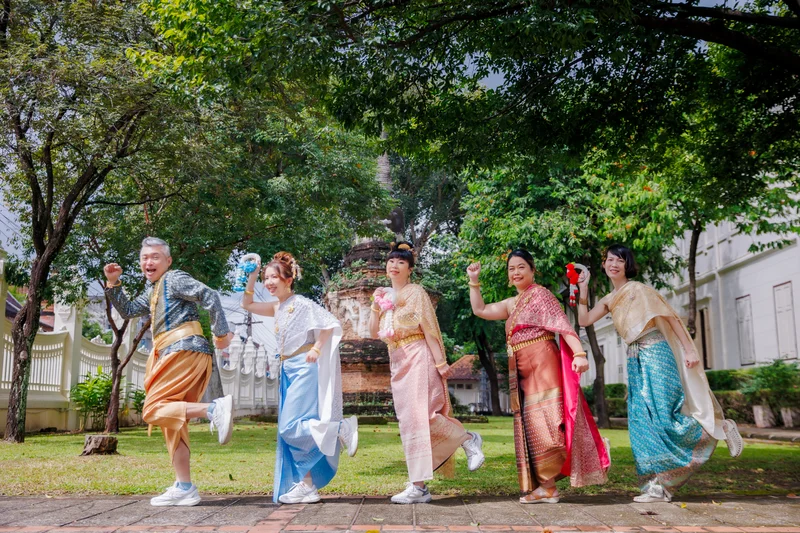 Couple wearing matching Thai traditional costumes at Wat Phra Singh in Chiang Mai