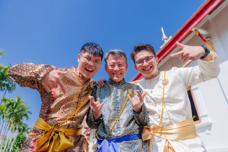 Three men in traditional Thai costumes at temple — group photoshoot