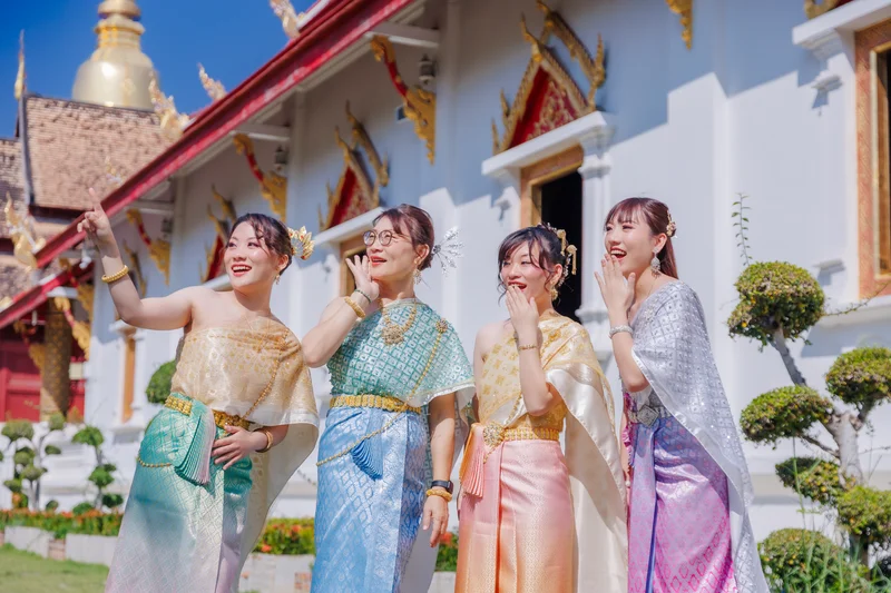 Group of men in Thai costumes at temple grounds