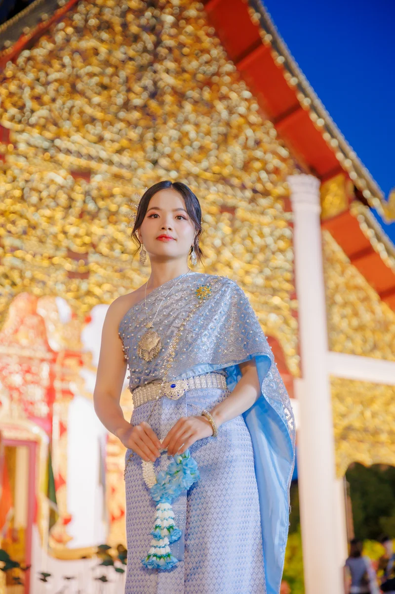 Woman in blue Thai dress at temple — professional photography