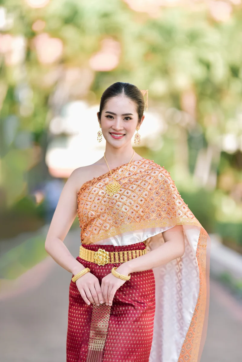 Woman in orange and gold Thai Sabai dress in garden — Sabai Thai Dressing