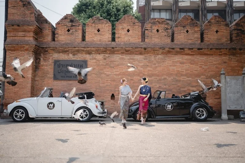 Two women walking with vintage beetles at Tha Phae — Sabai Thai Dressing